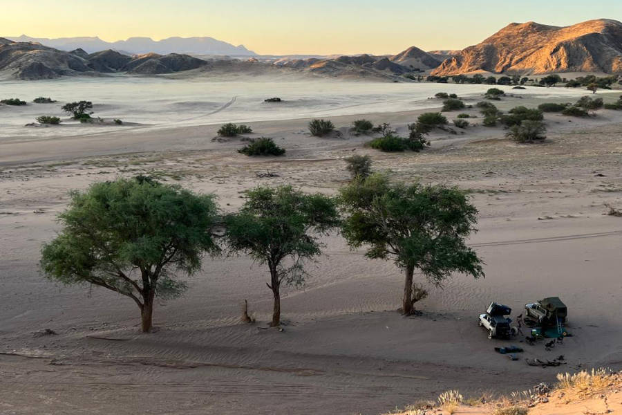 Two 4x4 vehicles parked in the namibian wilderness